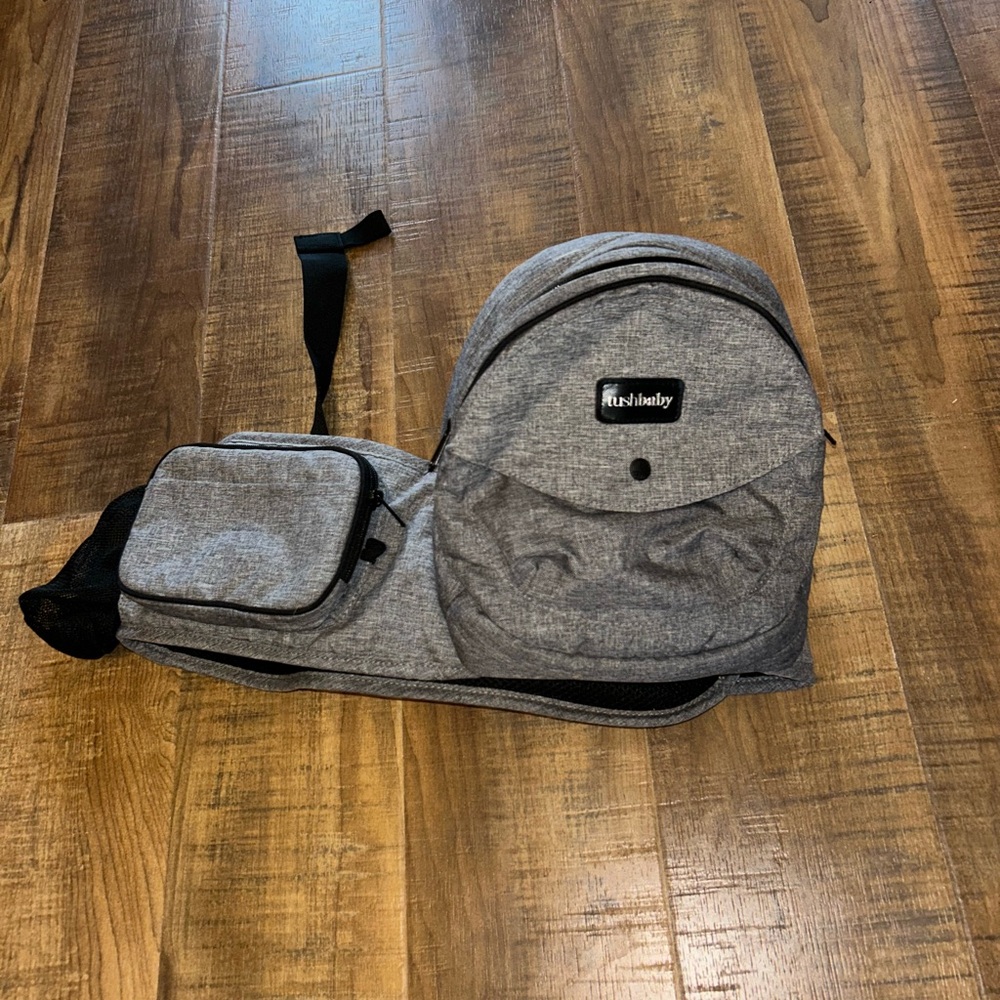 Gray TUSHBABY baby/ child carrying system.